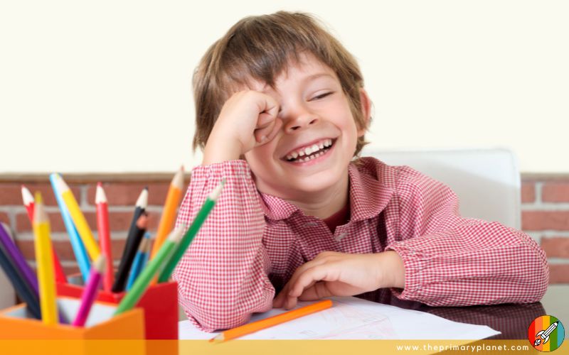 boy laughing at a picture writing prompt during writing time